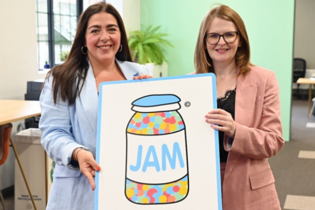 Minister Archibald and Maeve Monaghan, Chief Executive of NOW Group holding a placard showing the JAM card