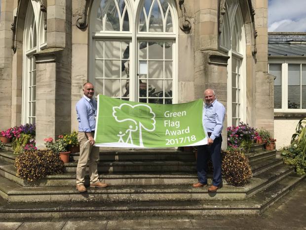 Stormont Estate management unit staff pictured holding a green flag award banner for 2017